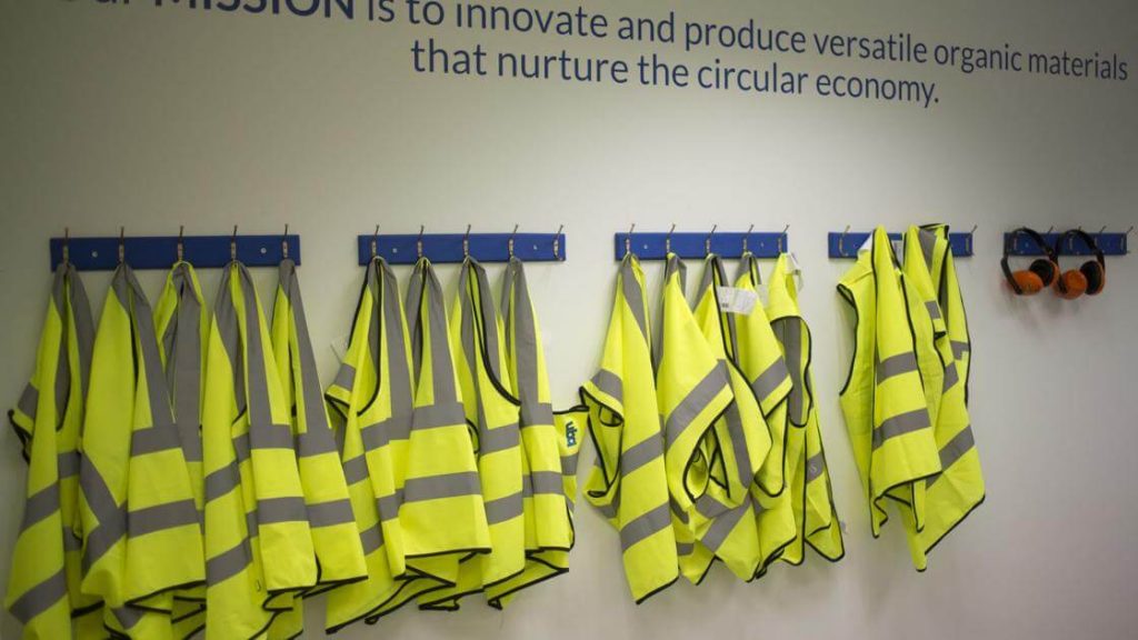 Safety jackets hung up on the wall at the UBQ factory