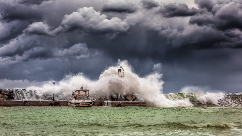 Big waves crash along coastline.