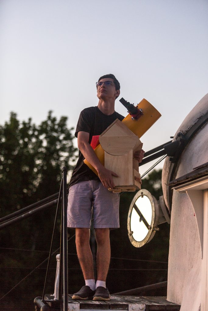 Zane and one of his homemade telescopes.
