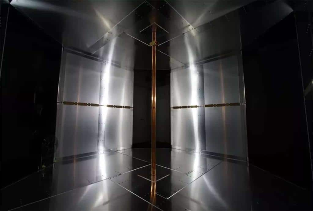 The magnetic field subsequently circulates clockwise and counter-clockwise around a copper pole in the center of the room