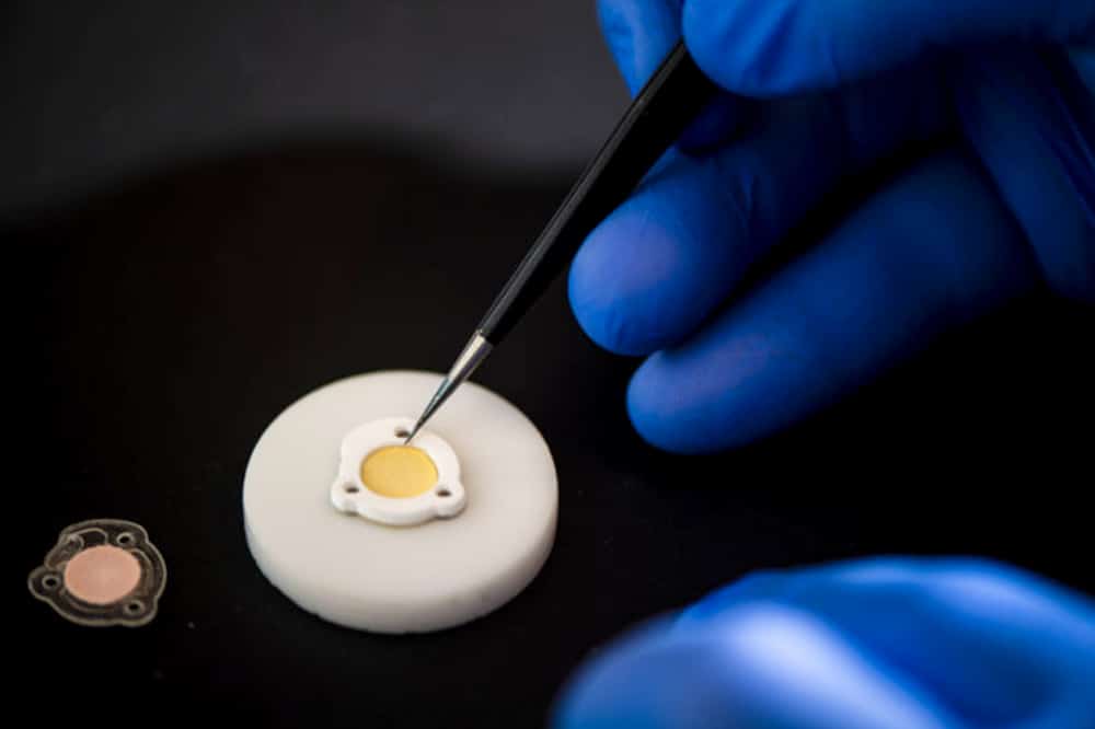 Wilson prepares the device to react to light, demonstrating how fluid activates the UV sensor