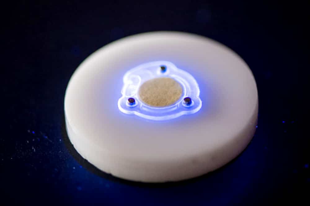 Wilson uses a UVA LED flashlight to demonstrate how the device reacts to light. The demonstration shows how the paper that starts yellowish turns red if exposed to damaging levels of UV radiation.