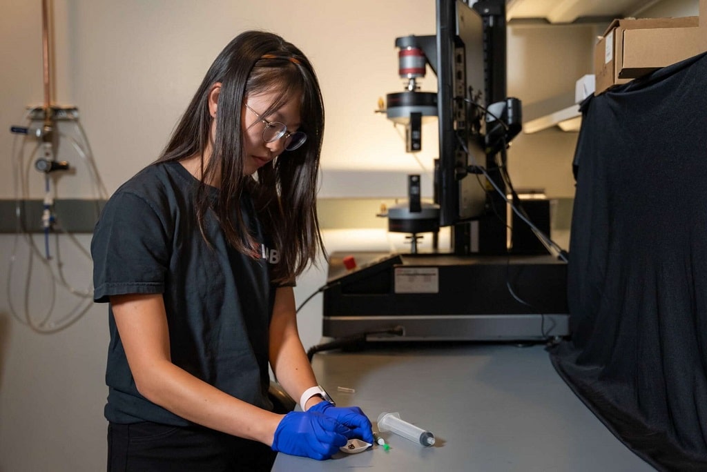 Rice University graduate student Faye Yap attaches a deceased wolf spider to a needle and feeds air into its limbs to act as a gripper