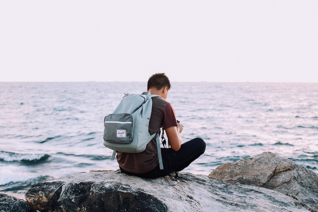 A man on the shore in one of the budget-friendly weekend getaway places near NYC