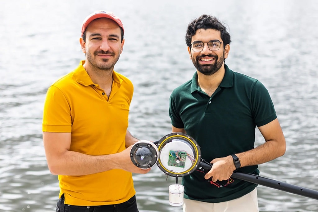 Research assistant Waleed Akbar (right) and Assoc. Prof. Fadel Adib (left) with the underwater camera that their team developed.