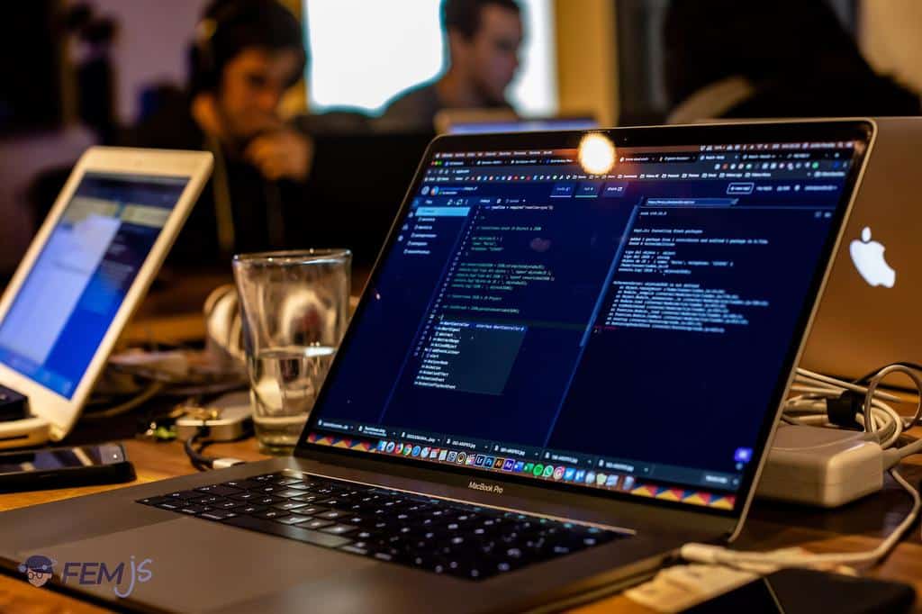laptop displaying code in an office