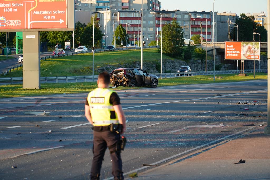 police officer looking at car wreck