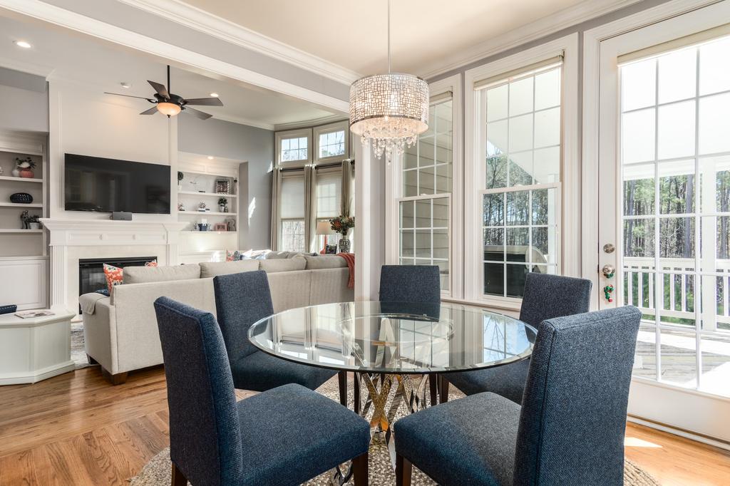 beautiful dining room with glass table and chandelier