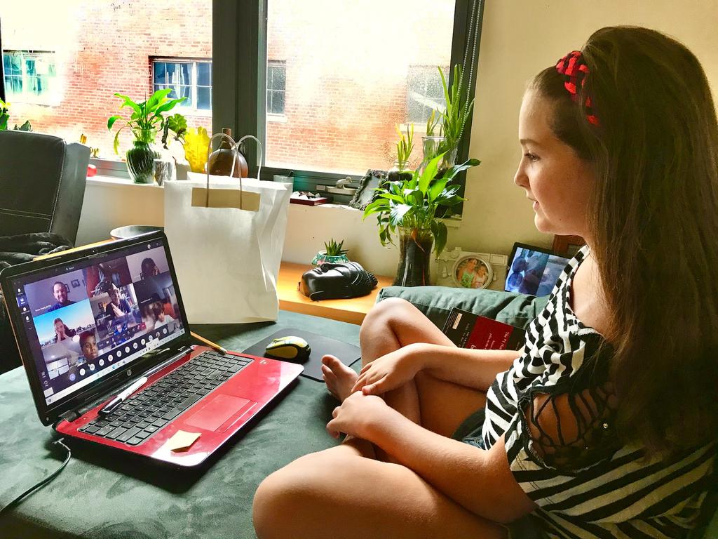 girl engaging in online schooling on laptop