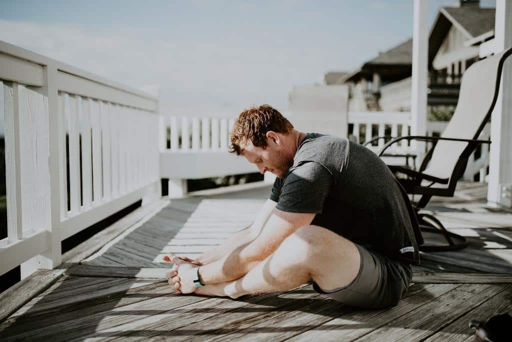 man stretching on deck