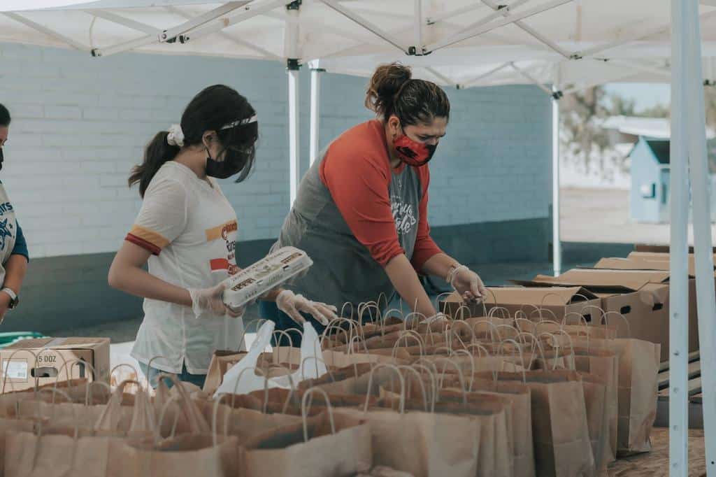 workers packing bags of food for delivery