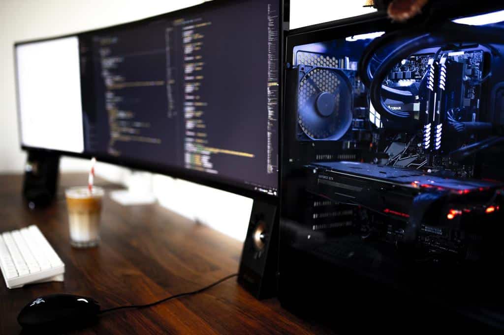 open computer case and two monitor displays
