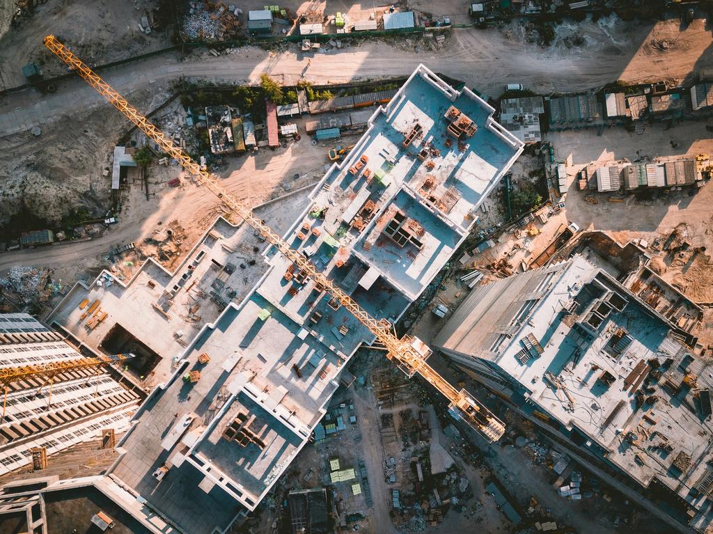 aerial view of cranes atop buildings under construction