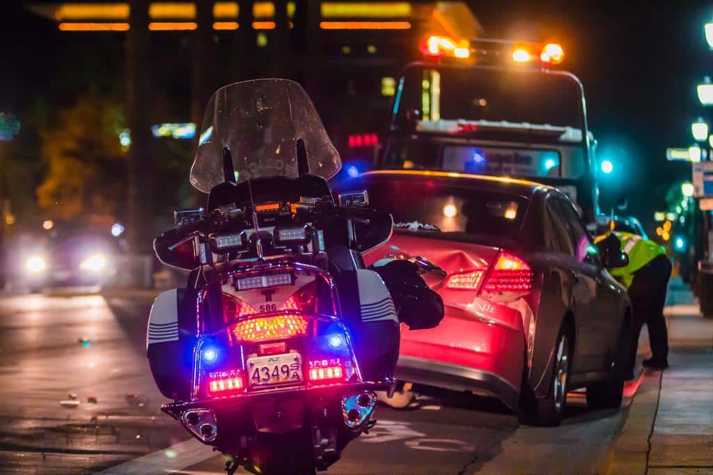 motorcycle police vehicle behind a car recently in an accident