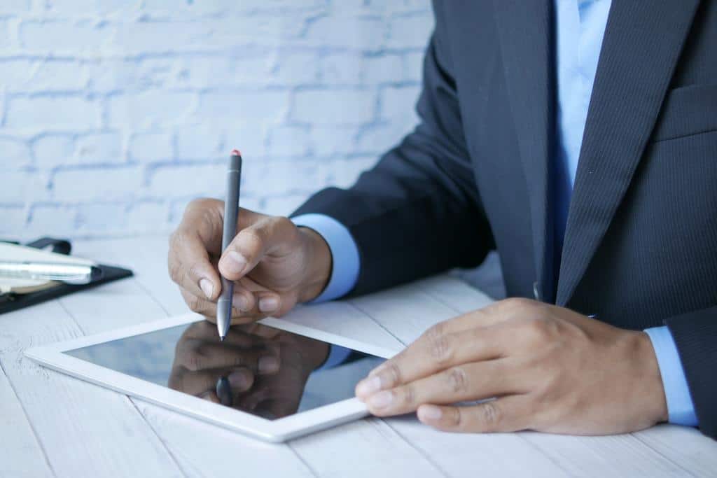 person using a tablet with stylus