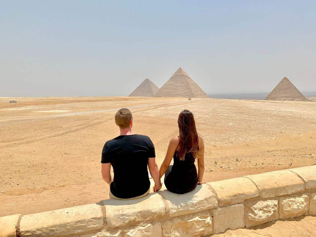 couple sitting at great pyramids
