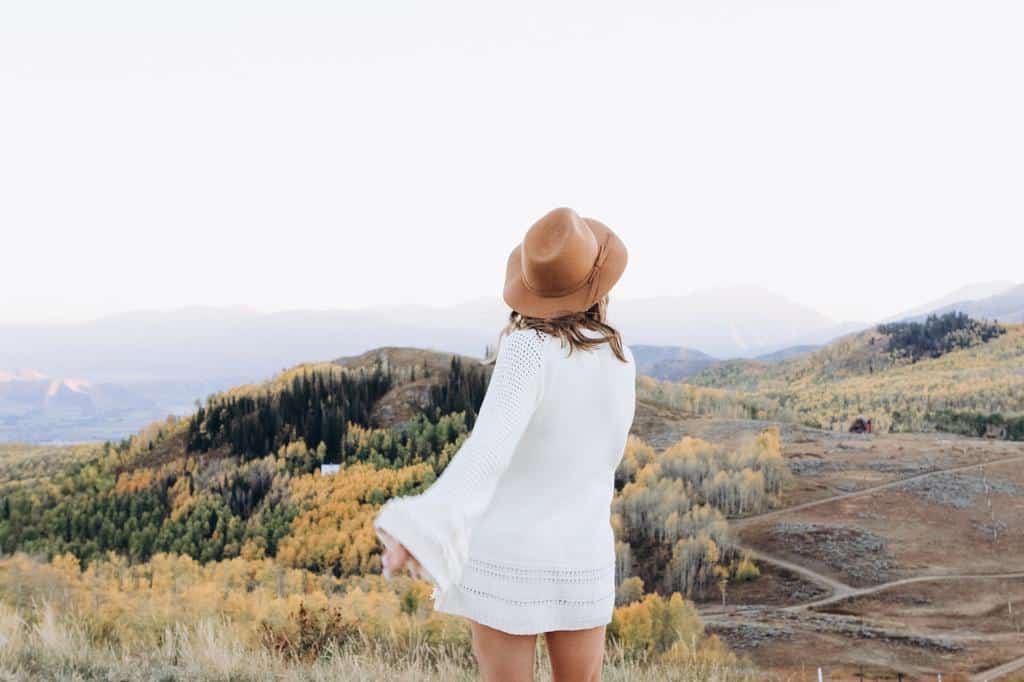 woman standing in hilly scenery