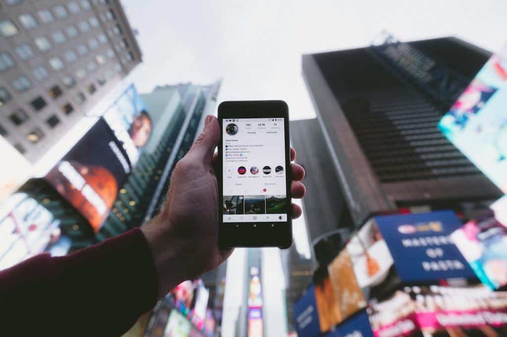 smartphone held up to city skyline