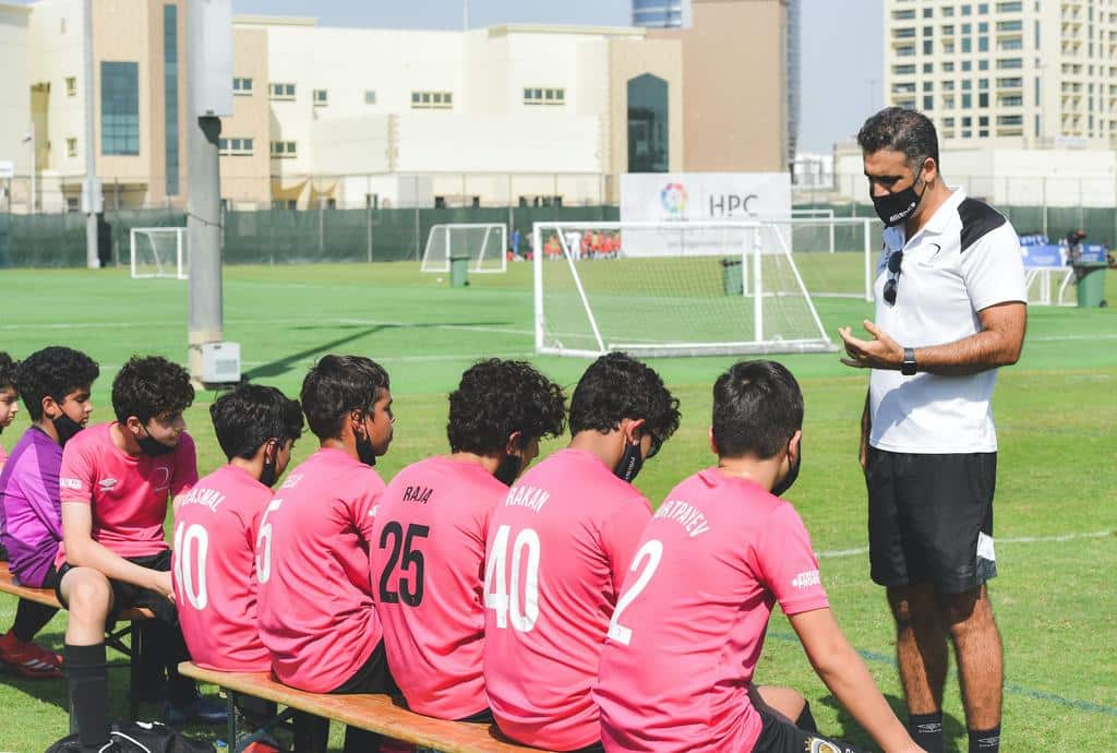 coach speaking to sports team