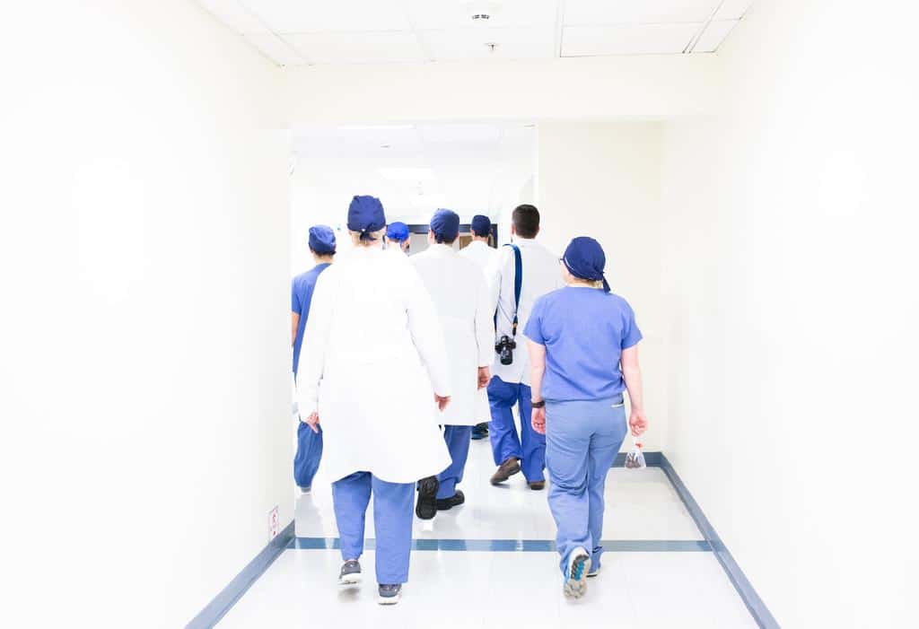 team of nurses walking away down hall