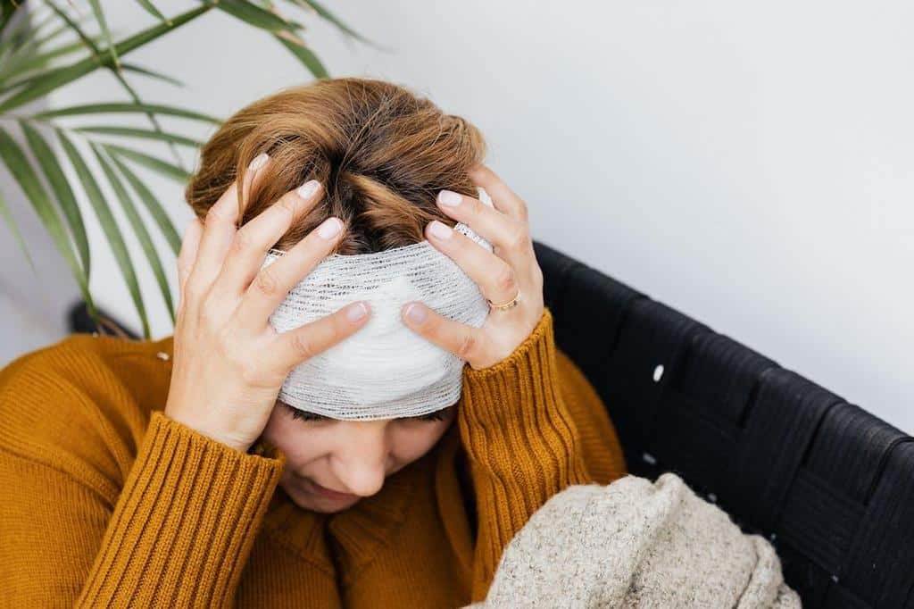 injured person's head wrapped in bandages