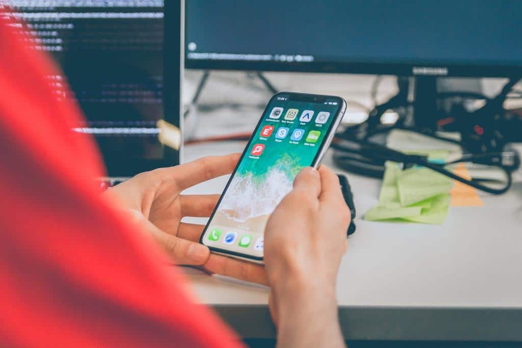 person looking at apps on phone