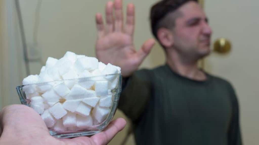 person with hand up to large portion of marshmallows