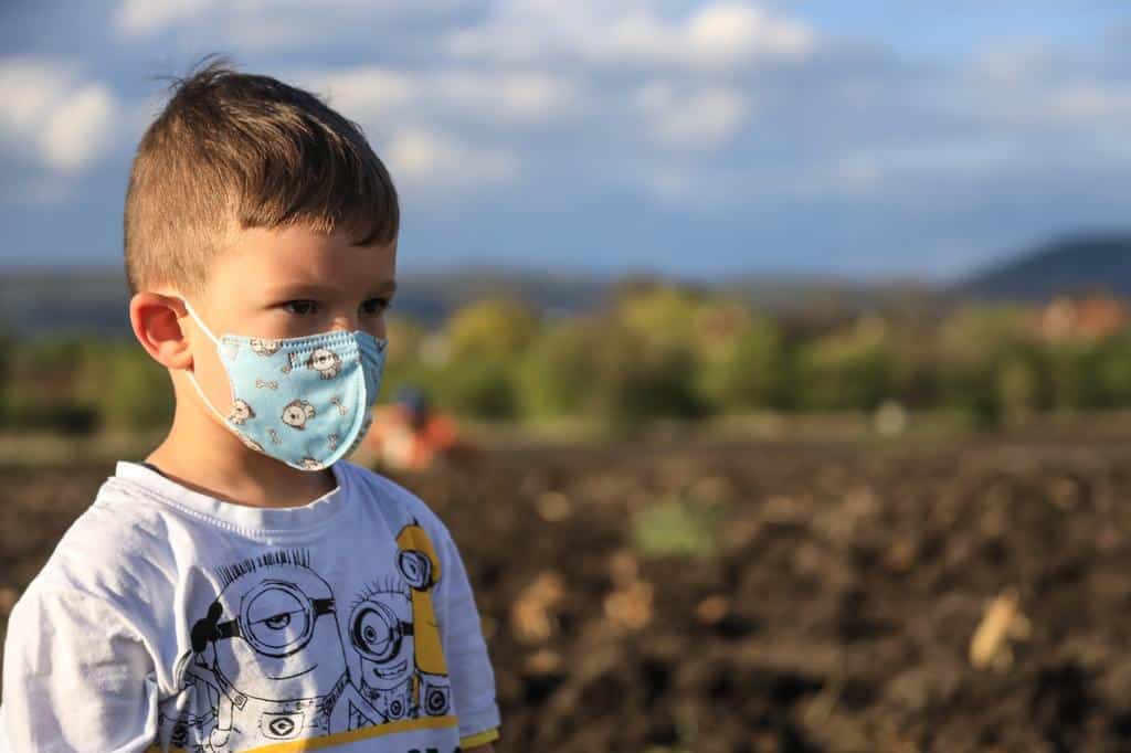 sick child wearing face mask