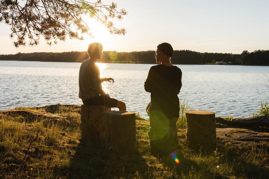 two people talking by the lake