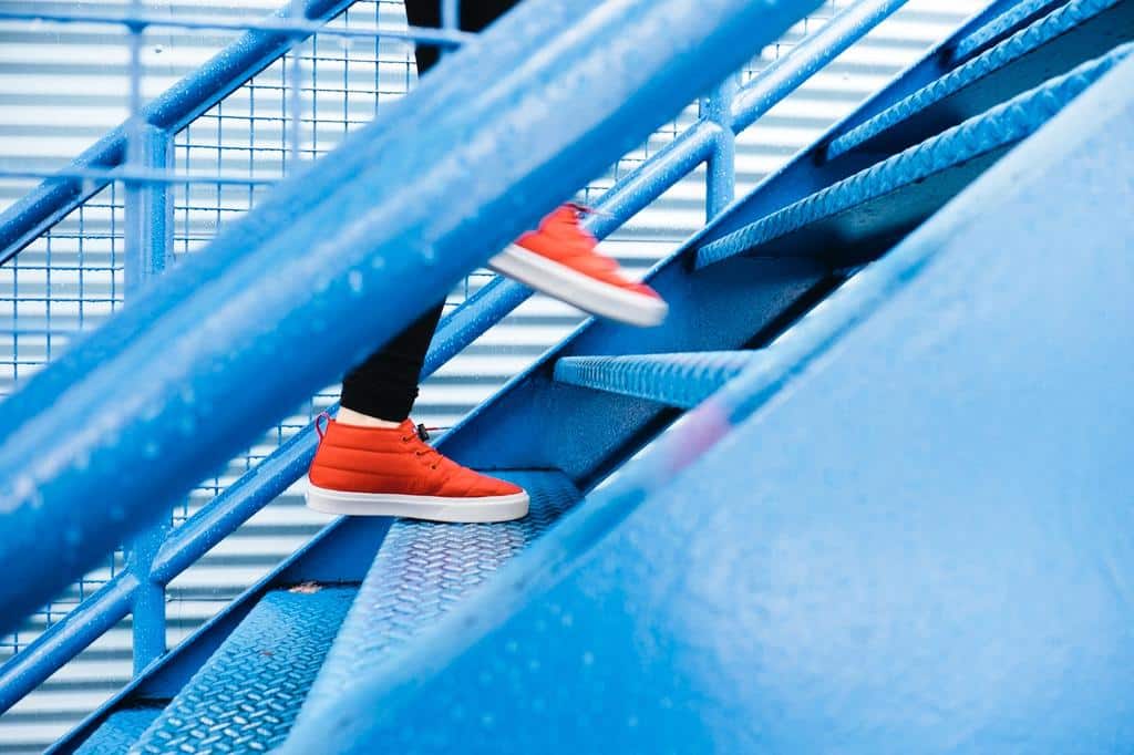 person walking up flight of stairs outdoors