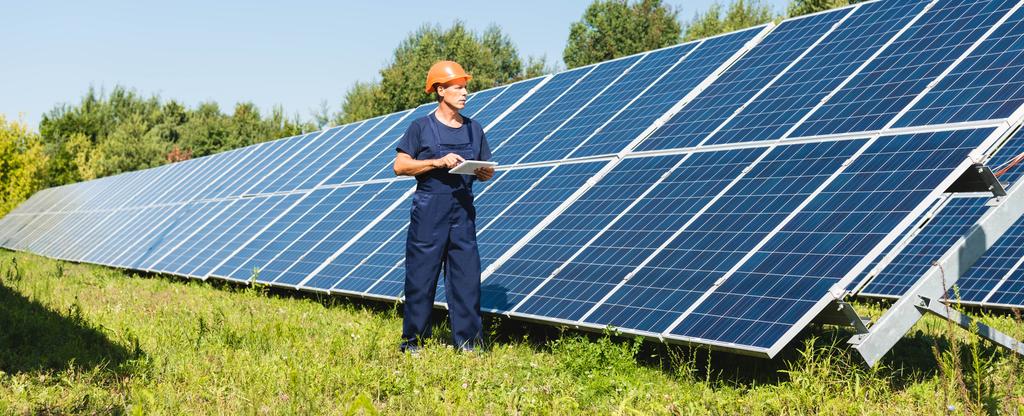 Man standing by installed outdoor solar panels