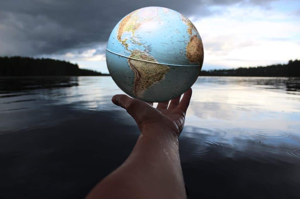 hand holding up a globe