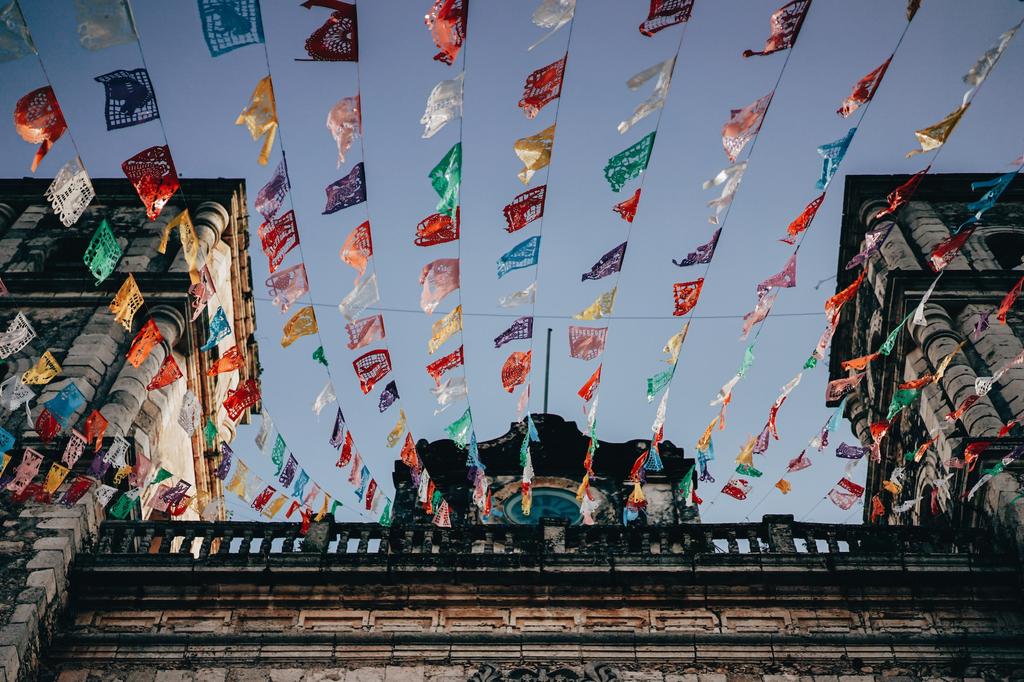 prayer flags hang from a building in Mexico