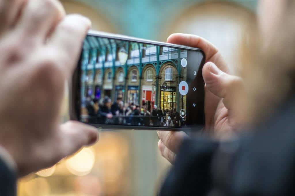 person recording video on mobile device