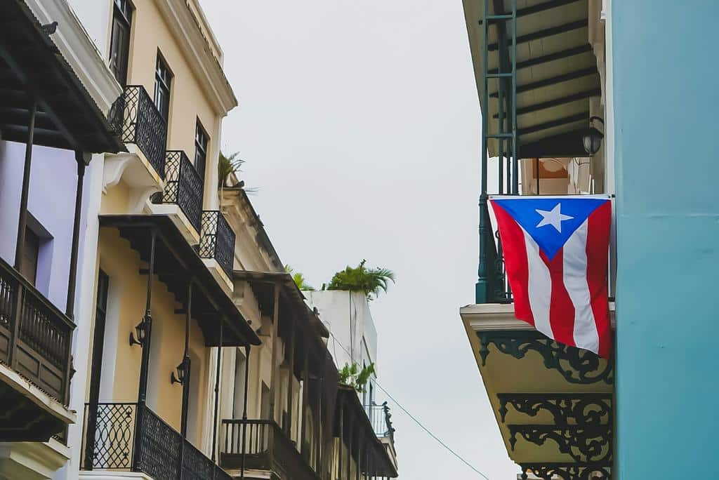 Puerto Rican flag hanging from balcony in a neighborhood in San Juan