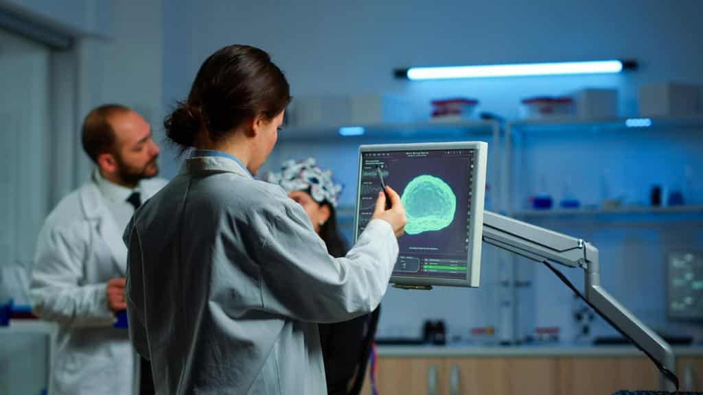 lab technicians examining scan results