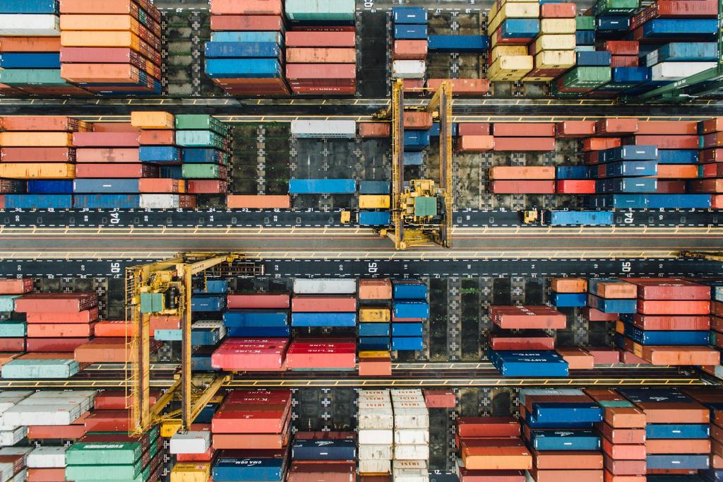 view of port dockyard from above filled with shipping containers