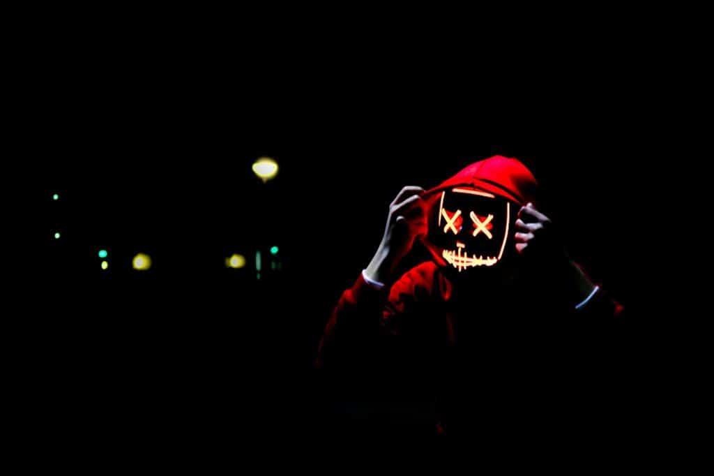 person wearing LED party mask