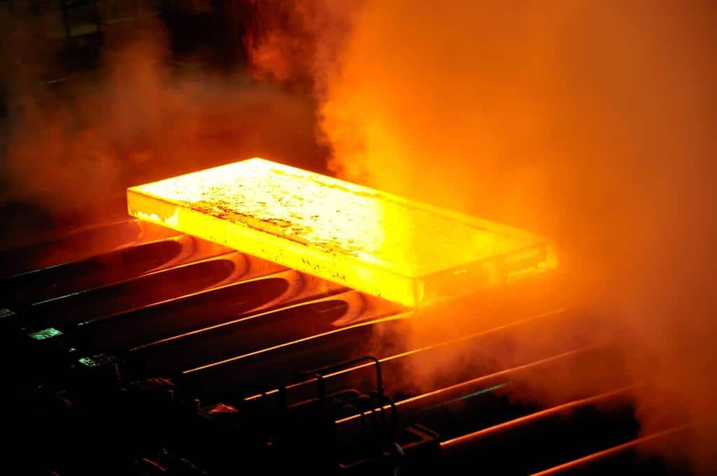 hot steel in forge rolling down conveyor