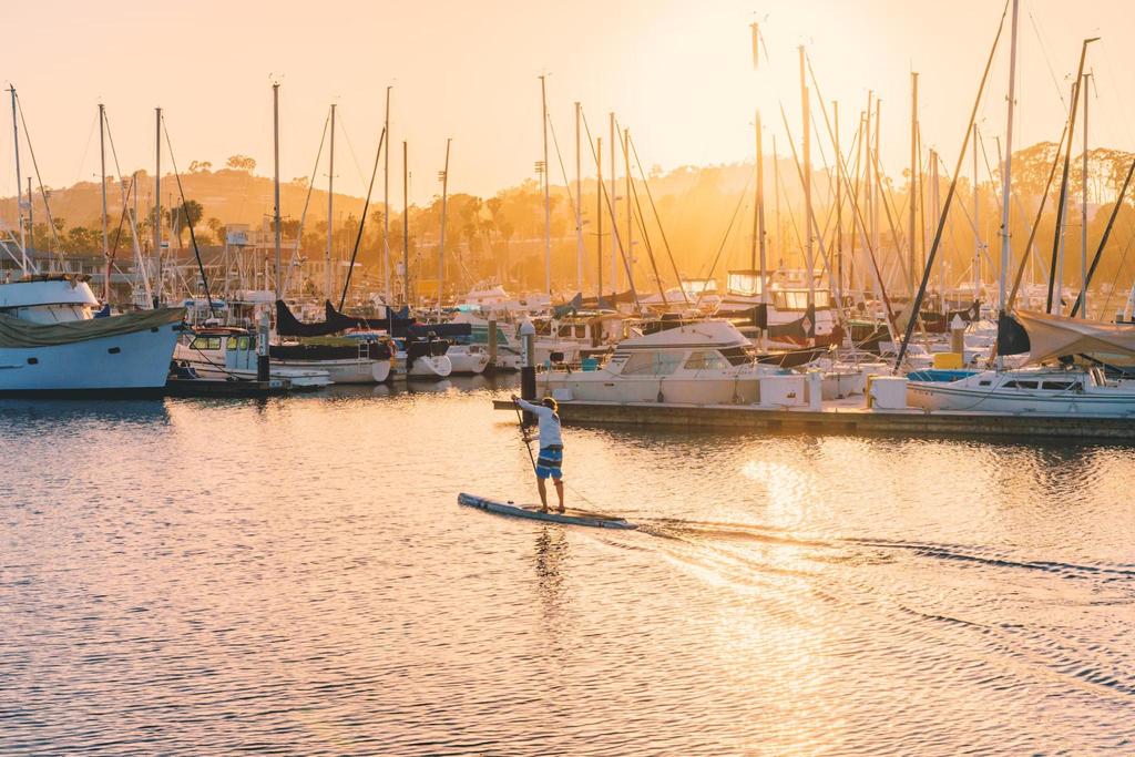 Challenge yourself by paddling in various water conditions, like choppy waves or strong currents.