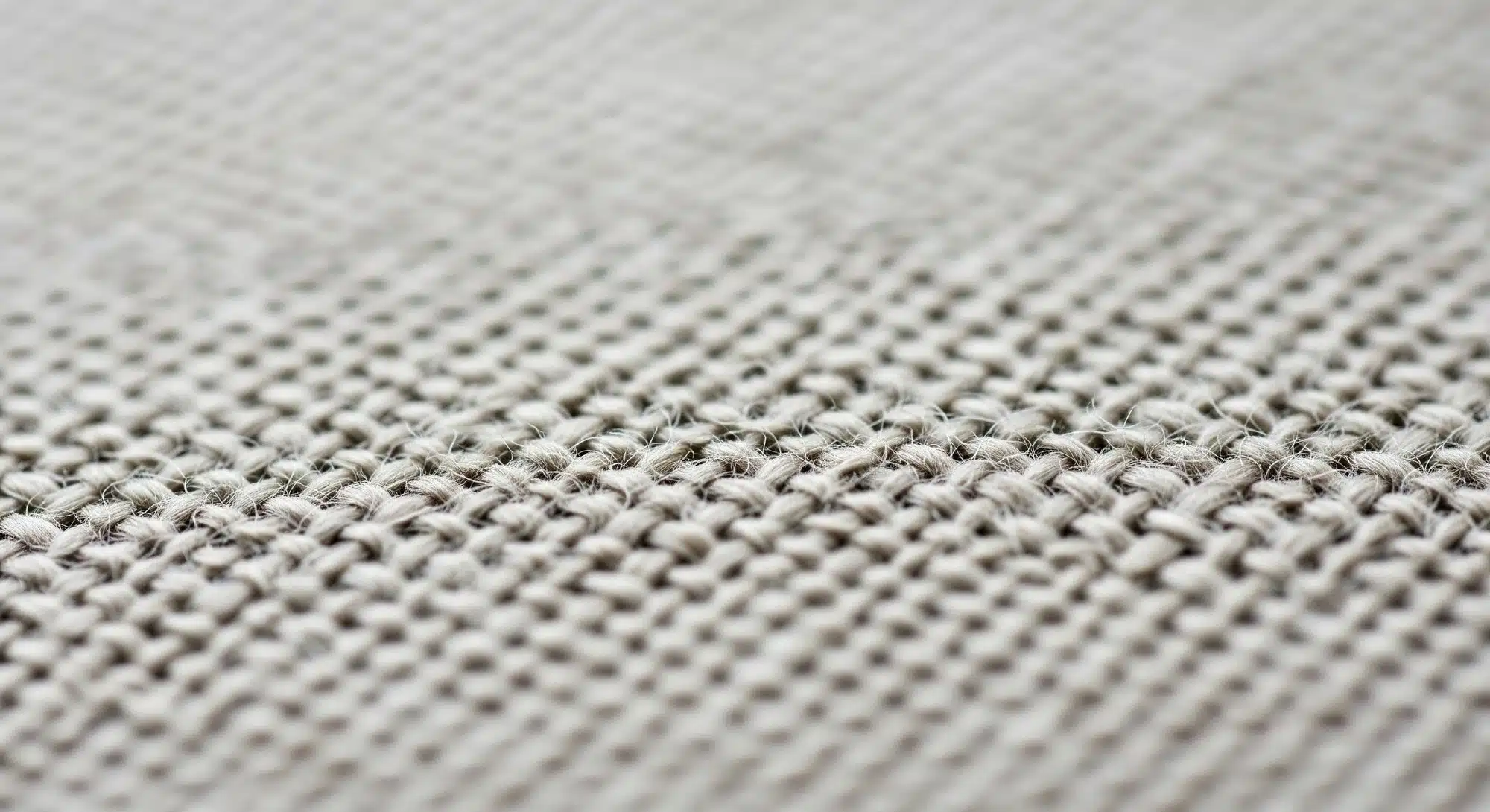 A close-up of high-quality linen curtain fabric showing the natural flax texture and weave.