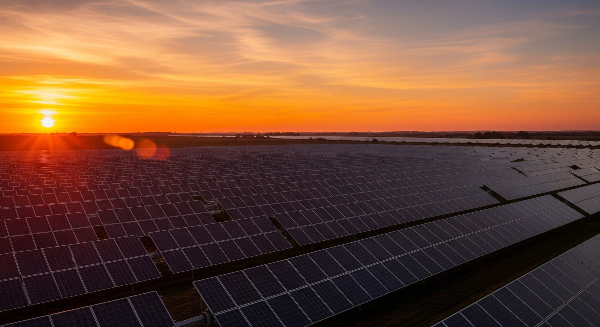 Solar panels glowing in golden sunset light representing a clean energy future