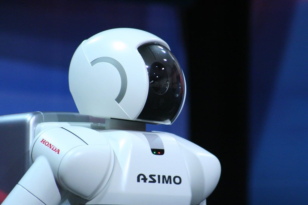 Close-up of the ASIMO robot by Honda, showing its white helmet with a dark visor