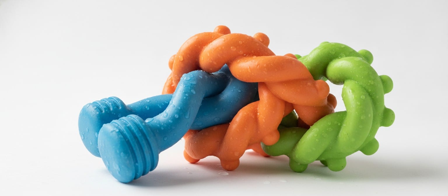 Close-up of durable TPE dog toys in various shapes showing flexibility and texture