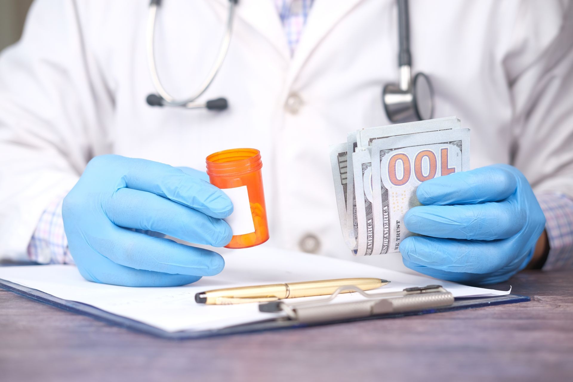 A person wearing a white coat and blue gloves holds an open prescription bottle in one hand and a fan of US dollar bills in the other, suggesting a transaction or cost associated with medication.