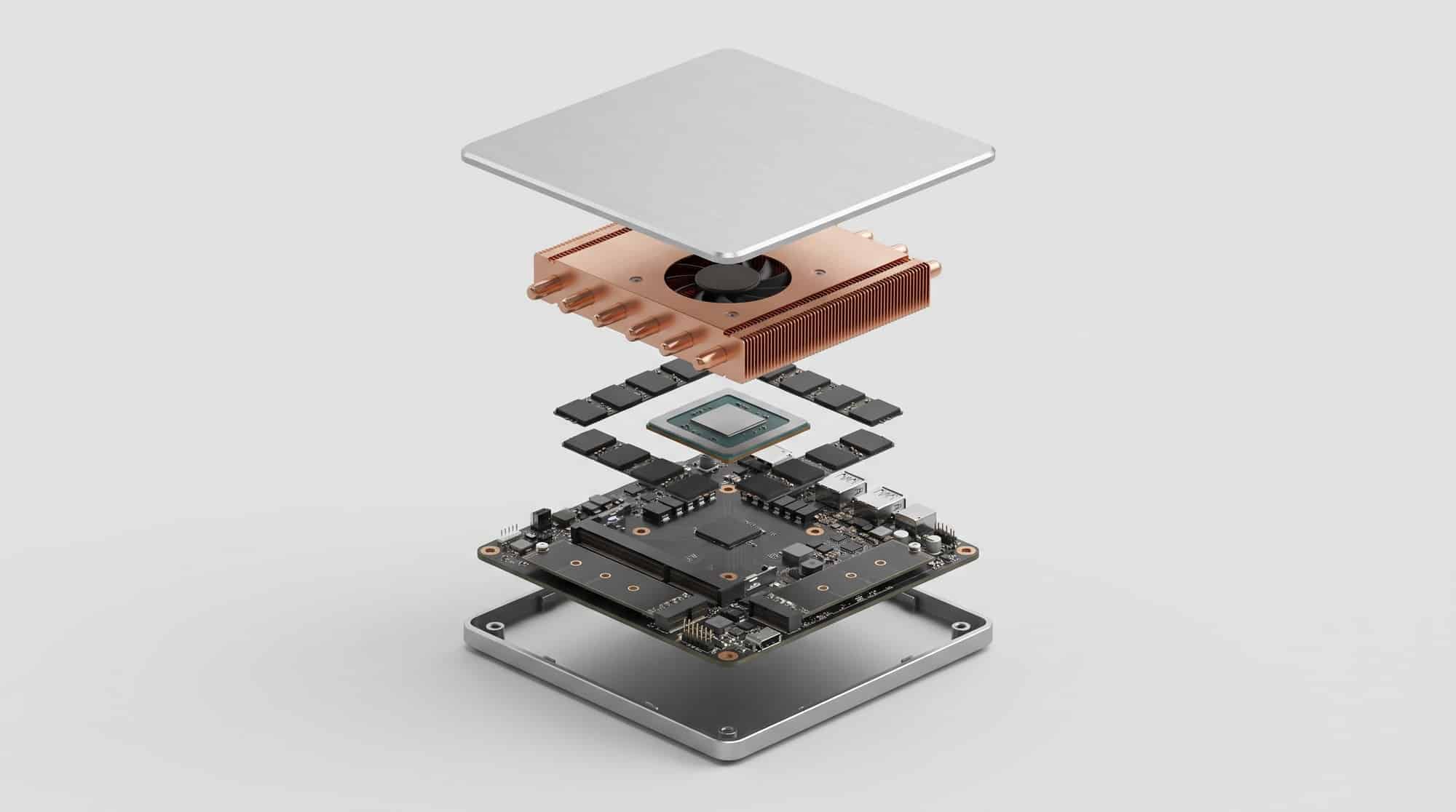 Cutaway view of a 192GB AI mini PC showing the processor, heatpipes, memory chips and storage slots