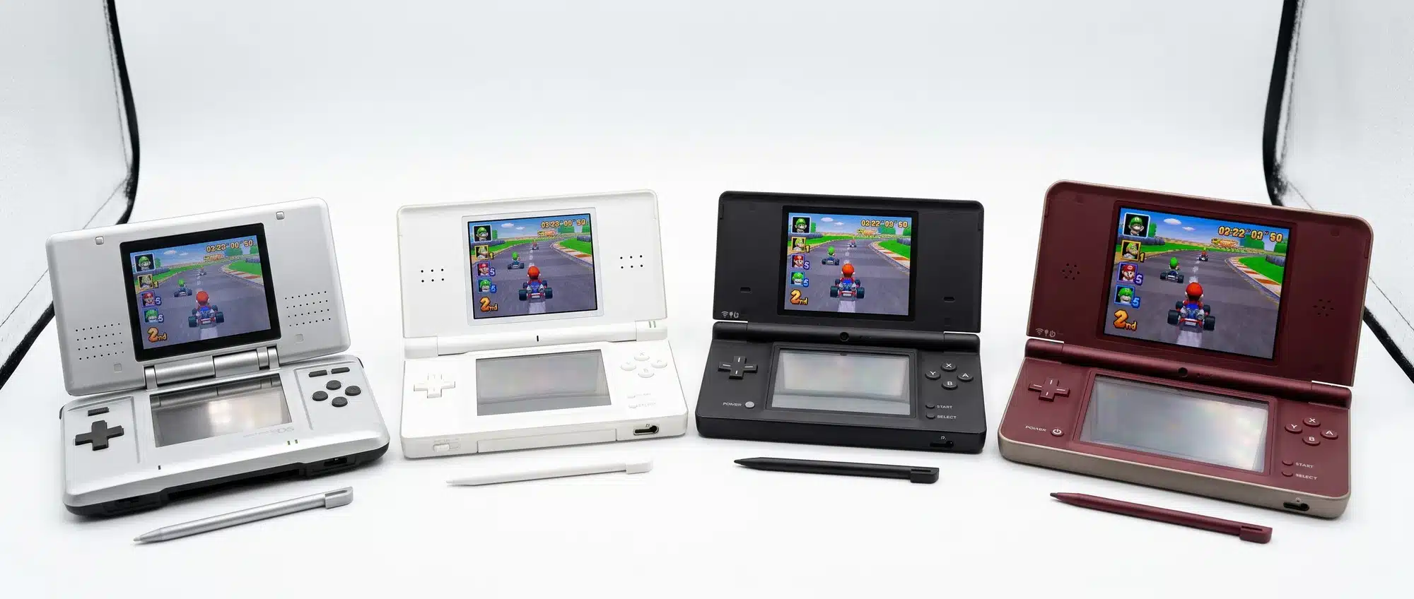 Nintendo DS family lineup with original DS Lite DSi and DSi XL models open