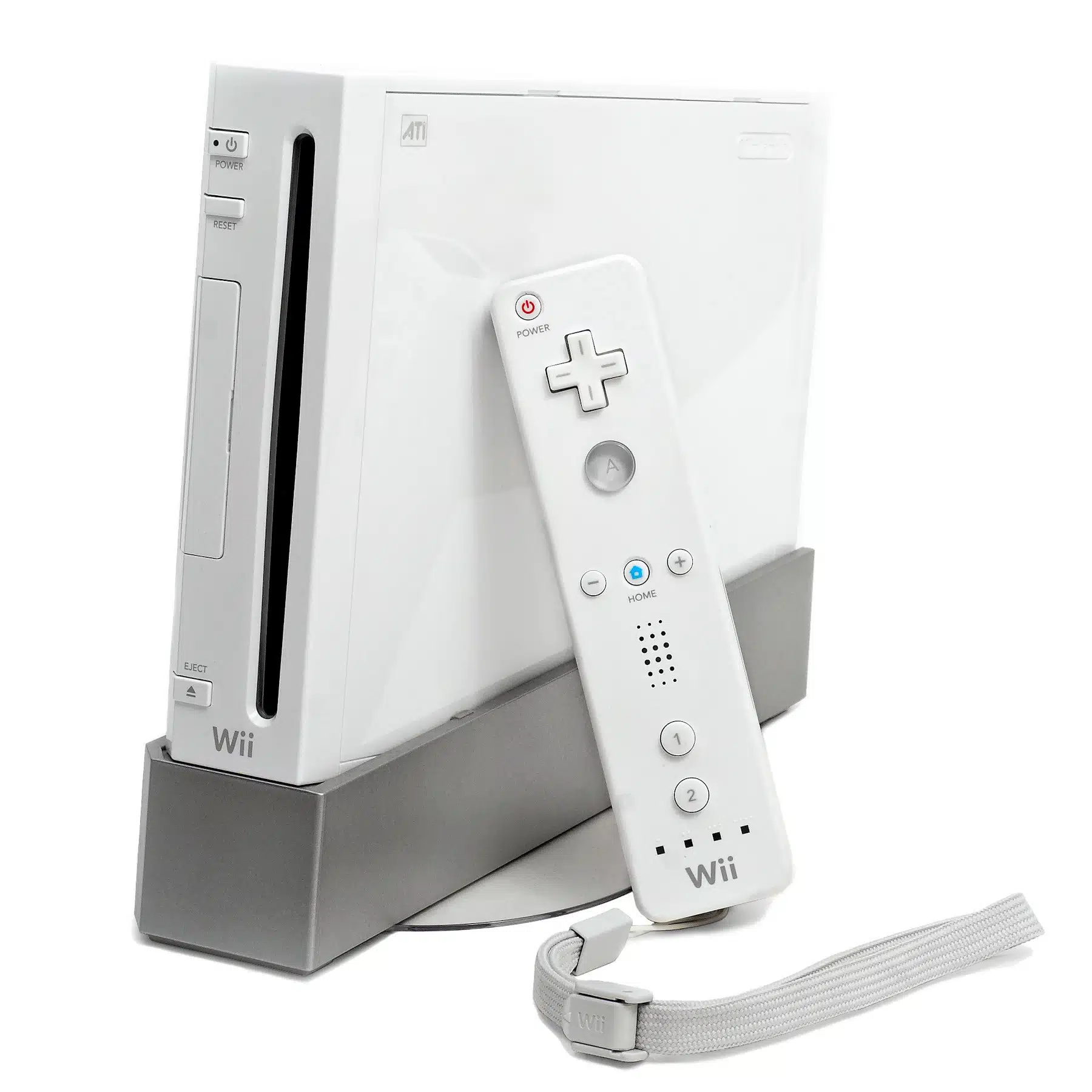 A white Nintendo Wii console is shown standing upright on a grey stand, with a white Wii Remote controller resting against it. The Wii Remote has a power button, a directional pad, A and Home buttons, and numbered buttons 1 and 2. A white wrist strap is attached to the bottom of the remote.