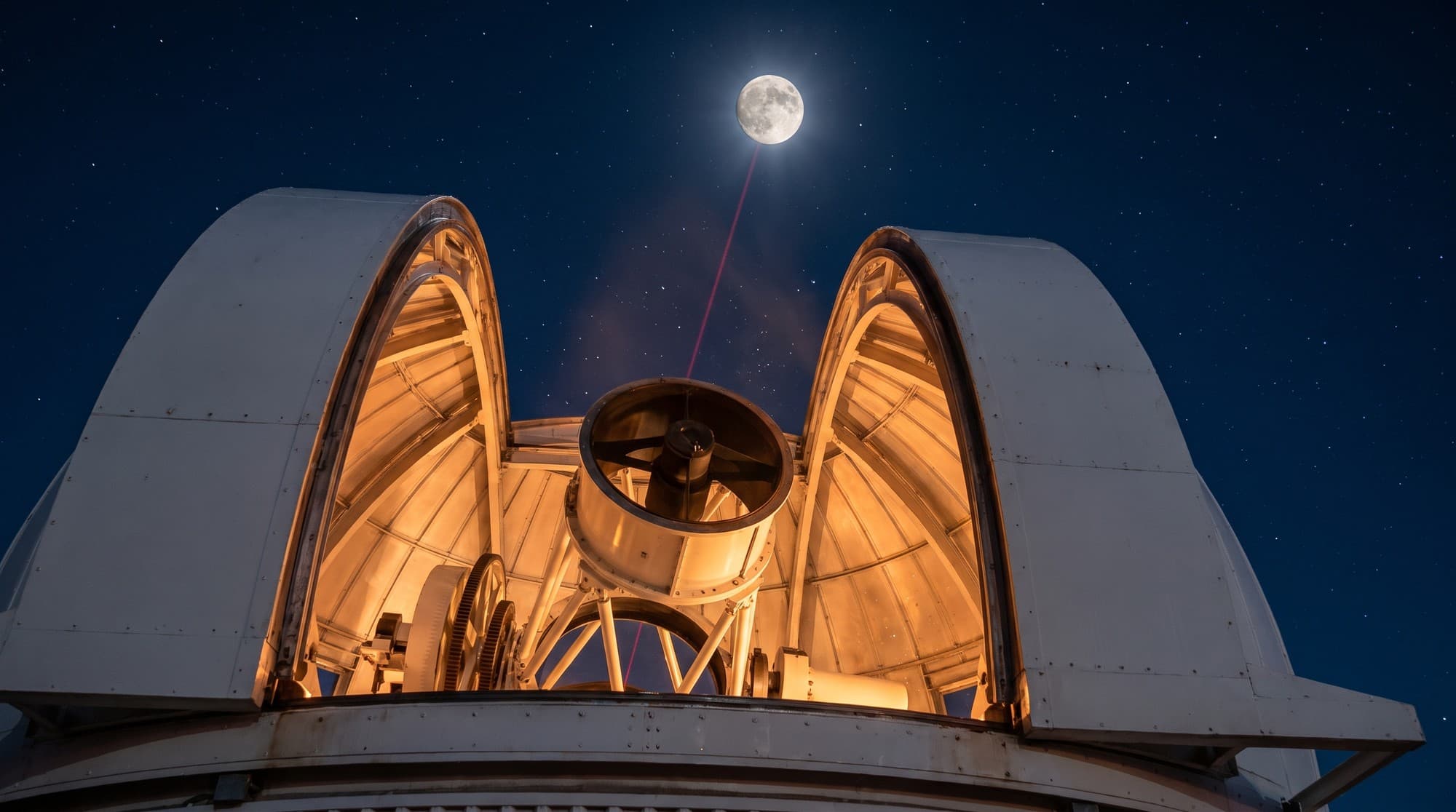 A large optical telescope in Yunnan province points at the Moon, firing a laser beam upward as part of China's Earth-Moon communication test