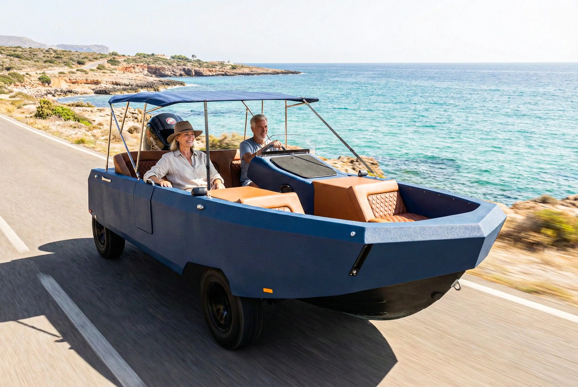 A WaterCar amphibious vehicle driving on a coastal road, blending car and boat capability in one machine, with a man at the wheel and a woman beside him.